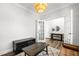 Comfortable sitting room with natural light, a brown sofa, stylish lighting, and hardwood floors at 139 Pronghorn Deer Ct, Garner, NC 27529
