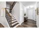 Elegant staircase with wood treads, dark railings, and white risers leading to the upper level of the home at 139 Pronghorn Deer Ct, Garner, NC 27529