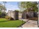 Professionally landscaped backyard with a charming gate and inviting stone pathway at 1403 Wake Forest Rd, Raleigh, NC 27604