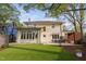 Exterior elevation view of a charming house with a manicured lawn, patio, and outdoor seating at 1403 Wake Forest Rd, Raleigh, NC 27604