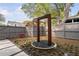 Private backyard featuring a modern water feature, stone path, and lush landscaping at 1403 Wake Forest Rd, Raleigh, NC 27604
