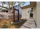 Cozy backyard with a unique water feature, stone pathway, and well-maintained landscaping at 1403 Wake Forest Rd, Raleigh, NC 27604