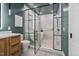 Modern bathroom featuring a glass-enclosed shower and soaking tub and a stylish wood vanity with stone countertop at 1403 Wake Forest Rd, Raleigh, NC 27604