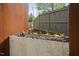 Inviting outdoor fire feature with modern stone surround and neutral colored privacy fence at 1403 Wake Forest Rd, Raleigh, NC 27604