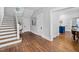 Bright foyer featuring hardwood floors and a classic staircase at 1403 Wake Forest Rd, Raleigh, NC 27604
