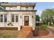 Charming home entrance features brick steps, a classic white door, and manicured landscaping at 1403 Wake Forest Rd, Raleigh, NC 27604