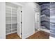 Hallway with built-in pantry, hardwood floors, and decorative wallpaper at 1403 Wake Forest Rd, Raleigh, NC 27604