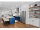 Contemporary kitchen with a large island, custom cabinetry, and stainless steel refrigerator at 1403 Wake Forest Rd, Raleigh, NC 27604