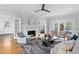 Living room with painted fireplace, french doors, hardwood floors and comfortable seating at 1403 Wake Forest Rd, Raleigh, NC 27604
