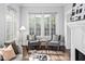 Cozy living room with hardwood floors, accent chairs, and ample natural light at 1403 Wake Forest Rd, Raleigh, NC 27604