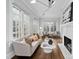 Bright living room featuring hardwood floors, a fireplace, and large windows at 1403 Wake Forest Rd, Raleigh, NC 27604