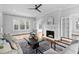Living room with painted fireplace, french doors, hardwood floors and comfortable seating at 1403 Wake Forest Rd, Raleigh, NC 27604