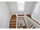 Bright stairwell featuring hardwood floors and white trim with a view of the foyer below at 1403 Wake Forest Rd, Raleigh, NC 27604
