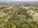 Aerial view of wooded neighborhood with a lake nearby at 15101 Aiken Rd, Wake Forest, NC 27587