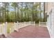 Back porch with a white railing overlooking wooded area at 15101 Aiken Rd, Wake Forest, NC 27587