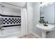 Traditional bathroom with shower/tub combination, tiled backsplash and pedestal sink at 15101 Aiken Rd, Wake Forest, NC 27587