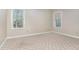 Neutral bedroom with two windows bringing in ample light and wooded views at 15101 Aiken Rd, Wake Forest, NC 27587
