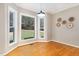 Light-filled breakfast nook with hardwood floors and large windows offering backyard views at 15101 Aiken Rd, Wake Forest, NC 27587