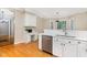 Bright kitchen featuring stainless appliances, white cabinetry and light countertops adjacent to hall at 15101 Aiken Rd, Wake Forest, NC 27587