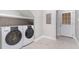 Functional laundry room with side-by-side washer and dryer and easy access to the exterior at 15101 Aiken Rd, Wake Forest, NC 27587