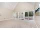 Spacious living room featuring high ceilings, plush carpet, and natural light, creating a welcoming ambiance at 15101 Aiken Rd, Wake Forest, NC 27587