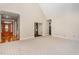 Spacious living room with a high ceiling, neutral carpet, and an open transition to the front foyer at 15101 Aiken Rd, Wake Forest, NC 27587