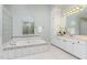 Bright main bathroom features a large soaking tub, tiled surround, and abundant natural light at 15101 Aiken Rd, Wake Forest, NC 27587