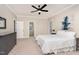 Spacious main bedroom with neutral decor, a ceiling fan, large windows and hall to bath at 15101 Aiken Rd, Wake Forest, NC 27587