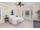 Spacious main bedroom features neutral decor, a ceiling fan, and large windows with views at 15101 Aiken Rd, Wake Forest, NC 27587