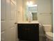 Bathroom featuring vanity with dark cabinets and mirror, and a white toilet at 1523 Yarborough Park Drive, Raleigh, NC 27604