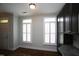 Entryway featuring hardwood floors, white wood trim, light gray walls, and windows with shutters at 1523 Yarborough Park Drive, Raleigh, NC 27604