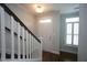 Entryway featuring a white door, hardwood floors, and white staircase with a window at 1523 Yarborough Park Drive, Raleigh, NC 27604