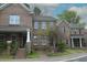 Brick townhome featuring a manicured lawn, gray roof, and brick steps leading up to the front door at 1523 Yarborough Park Drive, Raleigh, NC 27604