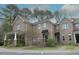 Beautiful brick townhomes featuring sidewalks, manicured lawns, awnings and well-kept landscaping at 1523 Yarborough Park Drive, Raleigh, NC 27604