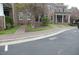 Exterior view of brick townhomes featuring well-kept lawns, landscaping, and sidewalk access at 1523 Yarborough Park Drive, Raleigh, NC 27604