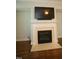 A modern fireplace with a white mantle and tile hearth at 1523 Yarborough Park Drive, Raleigh, NC 27604