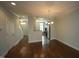 An open-concept living room and dining area with hardwood floors and natural light at 1523 Yarborough Park Drive, Raleigh, NC 27604