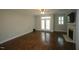 A bright living room featuring hardwood floors, a fireplace, and french doors at 1523 Yarborough Park Drive, Raleigh, NC 27604