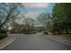 Wide street view showcasing the brick townhomes and manicured landscaping within the neighborhood at 1523 Yarborough Park Drive, Raleigh, NC 27604