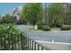 Street corner view of lush landscaping with a view of the brick townhomes in the neighborhood at 1523 Yarborough Park Drive, Raleigh, NC 27604