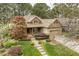 An aerial view showing a brick and stone home with lush landscaping, mature trees, and a charming front porch at 1525 Marshall Farm St, Wake Forest, NC 27587
