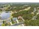 Aerial view showcasing homes near a golf course with a pond and mature tree coverage at 1525 Marshall Farm St, Wake Forest, NC 27587