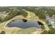 Aerial perspective of a golf course with a large pond and surrounding homes at 1525 Marshall Farm St, Wake Forest, NC 27587