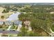 Aerial view of homes in a community with mature trees surrounding a golf course and pond at 1525 Marshall Farm St, Wake Forest, NC 27587