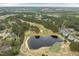 Overhead view of golf course with pond surrounded by green trees and residential area at 1525 Marshall Farm St, Wake Forest, NC 27587