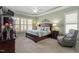 Bright bedroom featuring a ceiling fan, sitting area, and soft, neutral tones at 1525 Marshall Farm St, Wake Forest, NC 27587