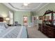 Spacious bedroom featuring tray ceilings, an armchair, and an ensuite bath at 1525 Marshall Farm St, Wake Forest, NC 27587