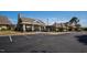 Exterior shot of the community clubhouse featuring covered seating, parking, and well-kept landscaping at 1525 Marshall Farm St, Wake Forest, NC 27587
