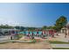 Expansive community pool featuring multiple pools, umbrellas, lounge chairs, and scenic views at 1525 Marshall Farm St, Wake Forest, NC 27587