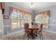 Bright dining area featuring a round table, wooden chairs, and a large window with shutters at 1525 Marshall Farm St, Wake Forest, NC 27587
